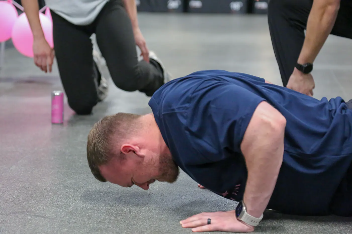 A coach mid push-up at Push for Pink 2025