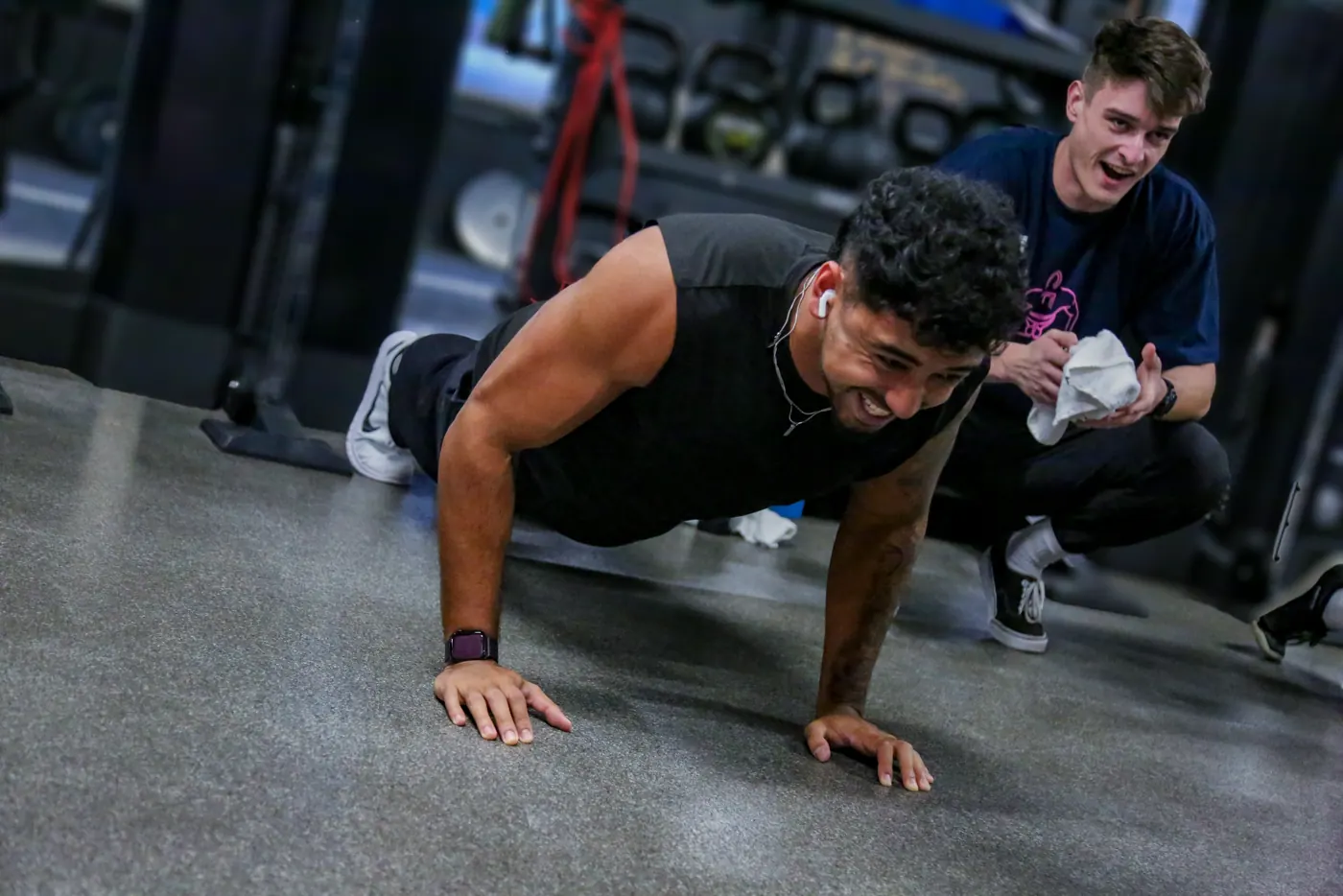 A coach grinning through his push-ups at Push for Pink 2025